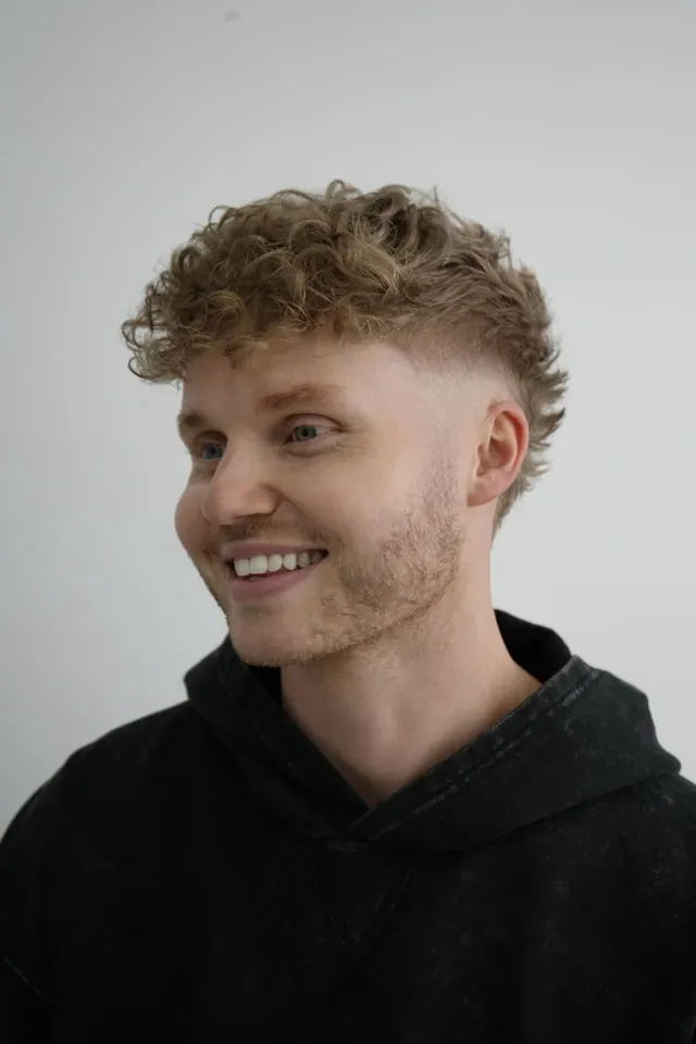 Curly textured top with a fade